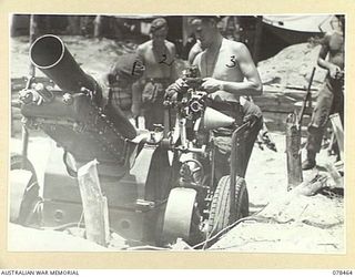 BOUGAINVILLE ISLAND, 1945-01-21. TROOPS OF NO.4 BATTERY, 2ND FIELD REGIMENT, CLEANING THEIR SHORT 25 POUNDERS AFTER A SHOOT AGAINST THE JAPANESE POSITIONS IN THE AREA. IDENTIFIED PERSONNEL ARE:- ..