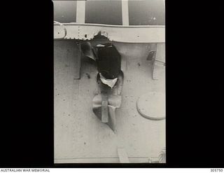 MILNE BAY. C.1943-04-14. THE ESCAPE HOLE OF A BOMB WHICH PENETRATED THROUGH THE BRIDGE STRUCTURE OF HMAS PIRIE BEFORE EXPLODING ON THE FORECASTLE. THE BOMB WAS DROPPED BY A JAPANESE AIRCRAFT WHEN ..