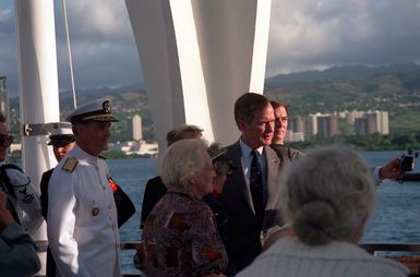 President George Bush speaks with guests as he prepares to depart from the USS ARIZONA MEMORIAL following an observance commemorating the 50th anniversary of the Japanese attack on Pearl Harbor