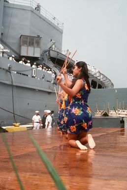 Dancers entertain visitors and crewmen of the combat stores ship USS NIAGARA FALLS (AFS 3) upon the ship's arrival at Naval Station Guam