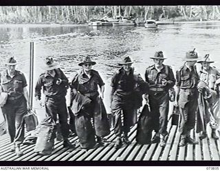 LABU, NEW GUINEA. 1944-06-17. MEMBERS OF THE AUSTRALIAN WAR DAMAGE COMMISSION ARRIVING TO INVESTIGATE WAR DAMAGE IN THE BULOLO-WAU AREA. LEFT TO RIGHT: MR R. J. CLAPE, CLAIMS OFFICER; MR J. F. N. ..
