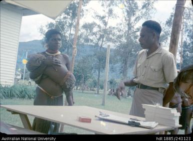 Mother and child collecting ballot paper
