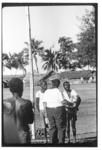 Men gathered beside flagpole