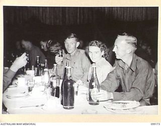 LAE, NEW GUINEA, 1945-12-01. PERSONNEL, ATTENDING A FORMAL MESS IN THE SERGEANTS' MESS, 2/1 BASE WORKSHOP, ON THE OCCASION OF THE THIRD ANNIVERSARY OF THE FORMATION CORPS OF AUSTRALIAN ELECTRICAL ..