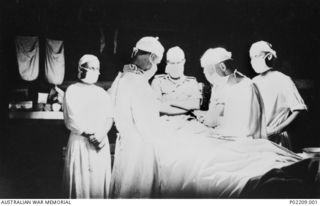 Bougainville, New Guinea, 1945-09. Royal Australian Army Medical Corps (RAAMC) surgeons operating on a patient in the operating theatre at the 2/1st Casualty Clearing Station. (Donor M. Zaetta)