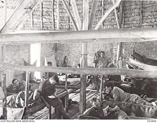 SOGERI VALLEY, NEW GUINEA. 1943-06-25. PORTION OF ONE OF THE WARDS OF THE MAIN DRESSING STATION OF THE 11TH AUSTRALIAN FIELD AMBULANCE. PATIENTS ARE FROM 25TH BATTALION, 61ST BATTALION, DIVISION HQ ..