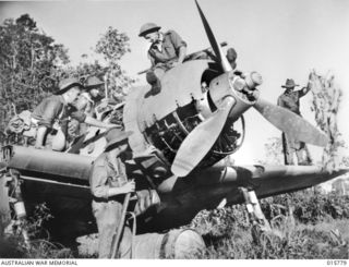 1943-09-22. NEW GUINEA. AUSTRALIAN TROOPS CAPTURE LAE. AUSTRALIANS INSPECT A JAPANESE ZERO AIRCRAFT ABANDONED AT LAE. LEFT TO RIGHT - PTE. R. KELLY OF PADDINGTON, N.S.W., CPL. J. HARRISON OF ..