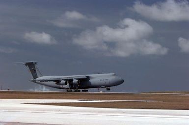 A C-5 Galaxy aircraft out of Travis Air Force Base, California, lands at Andersen Air Force Base, Guam, to deliver power trucks from Hawaii that will aid the Guam Power Authority in restoring power to the island after Typhoon Paka