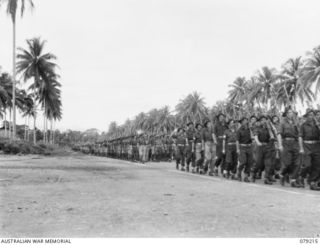 AITAPE, NEW GUINEA. 1945-02-23. PERSONNEL OF THE 2/4TH INFANTRY BATTALION GIVE EYES RIGHT AS THEY PASS THE GENERAL OFFICER COMMANDING, 6TH DIVISION DURING THE MARCH PAST OF THE 19TH INFANTRY ..