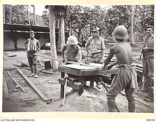 RABAUL, NEW BRITAIN. 1945-11-10. JAPANESE TROOPS SAWING TIMBER AT 118 GENERAL HOSPITAL FOR USE IN HOSPITAL BUILDINGS. SAPPER M. OUTRAM (1) AND CORPORAL A.J. REID (2), MEMBERS OF 16 FIELD COMPANY, ..