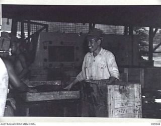 RABAUL, NEW BRITAIN, 1946-03-29. JAPANESE LABOURERS WASHING AND CASING BOTTLES AT THE AUSTRALIAN ARMY CANTEENS SERVICE CORDIAL FACTORY. THE FACTORY, STAFFED BY SEVEN SKILLED ARMY PERSONNEL, A ..