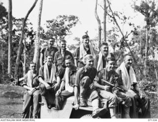 WAREO, NEW GUINEA, 1944-03-20. MEMBERS OF THE 29/46TH INFANTRY BATTALION IN A JEEP ON THEIR WAY TO THE BATHS. IDENTIFIED PERSONNEL ARE: VX144237 PRIVATE P.H. HUTCHINSON (1); VX106033 PRIVATE A.H.S. ..