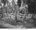 Native women washing clothes on sheets of galvanized metal, Rongerik Island, August 1947