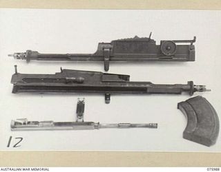 LAE, NEW GUINEA. 1944-09-15. THE EFFECTS OF TROPICAL CONDITIONS ON VARIOUS PARTS OF BREN GUNS USING ATLANTIC AEF.33M. THESE TRIALS OF CORROSION PREVENTING LUBRICANTS FOR SMALL ARMS UNDER TROPICAL ..