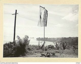 WUNUNG PLANTATION, JACQUINOT BAY, NEW BRITAIN. 1945-03-02. PENNANTS ON THE FLAGPOLE AT THE ENTRANCE TO THE 105TH CASUALTY CLEARING STATION