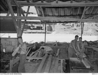 WUNUNG PLANTATION, JACQUINOT BAY, NEW BRITAIN, 1945-08-24. SAW BENCH CREW, 55 FIELD PARK COMPANY, ROYAL AUSTRALIAN ENGINEERS, IN THE WORKSHOP. IDENTIFIED PERSONNEL ARE:- SAPPER G. SINGLETON (1); ..