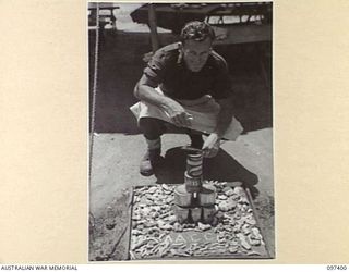 WEWAK POINT, NEW GUINEA. 1945-10-02. A SMARTNESS OF LINES COMPETITION WAS HELD AT 2/3 MACHINE-GUN BATTALION AND TROOPS WERE GIVEN A WEEK TO DECORATE THEIR LINES. THE COMPETITION WAS WON BY THIS 10 ..