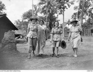 RABAUL, NEW BRITAIN. 1945-11-10. SUPERINTENDENT R.A. PARROTT, AUSTRALIAN RED CROSS, WITH THREE INDIAN RED CROSS GIRLS WHO WILL CARE FOR INDIAN PRISONERS OF WAR ON SHIPS RETURNING TO INDIA