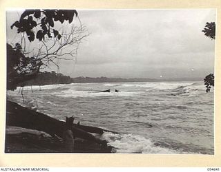 SIPILANGAN, NEW BRITAIN, 1945-07-30. THE VIEW LOOKING TOWARDS LAMARIEN AND MEVELO RIVER ACROSS THE HENRY REID BAY FROM TOL PLANTATION, SHOWING THE SURF ROLLING IN. THIS SURF PREVENTS BARGES FROM ..