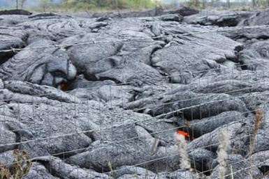 Red hot lava visible through the cracks as the lava cools.
