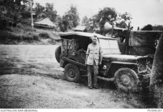 PORT MORESBY, PAPUA, 1943-12. SERGEANT LEN REMINGTON STANDING BESIDE THE JEEP THAT SERVED AS MOBILE CINEMA NO. 83, AUSTRALIAN ARMY AMENITIES SERVICE, BEFORE IT WENT TO BUNA. (DONOR: G. MASTERS)