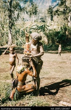 Adjusting head-dress for dance