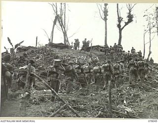 BOUGAINVILLE ISLAND. 1944-12-30. TROOPS OF D COMPANY, 25TH INFANTRY BATTALION MOVING UP THE TRACK ON LITTLE GEORGE HILL DURING THE AUSTRALIAN ATTACK ON JAPANESE POSITIONS IN THE PIATERAPAIA SECTOR