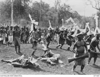 SONG RIVER, FINSCHHAFEN AREA, NEW GUINEA. 1944-03-26. FINSCHHAFEN BOYS DANCING DURING A NATIVE SING-SING IN THE AUSTRALIAN NEW GUINEA ADMINISTRATIVE UNIT COMPOUND TO CELEBRATE THE RE OCCUPATION OF ..