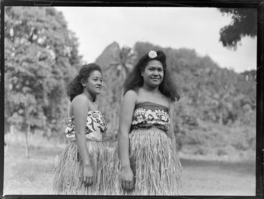Two unidentified local women wearing pareu laplaps and hula skirts, Rarotonga, Cook Islands