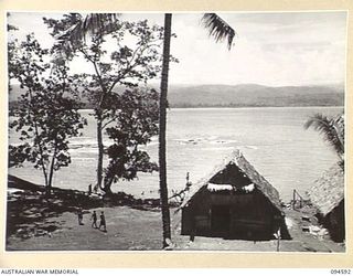 SIPILANGAN, NEW BRITAIN, 1945-07-27. THE COMMANDING OFFICER'S HOUSE AT THE AUSTRALIAN NEW GUINEA ADMINISTRATIVE UNIT REFUGEE CAMP. IT OVERLOOKS WIDE BAY WITH WAITAVALO IN THE BACKGROUND