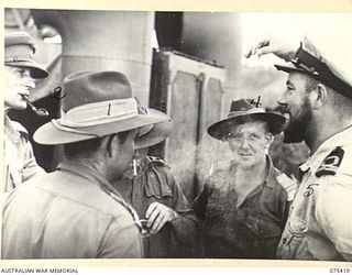 POTSDAM, NEW GUINEA. 1944-08-21. LIEUTENANT A. GOTT, ROYAL AUSTRALIAN NAVAL VOLUNTEER RESERVE (5), CHATTING WITH OFFICERS OF THE 30TH INFANTRY BATTALION ABOARD THE FRIGATE HMAS BARCOO. THIS VESSEL ..