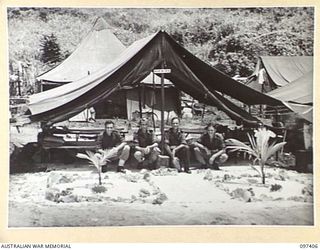 WEWAK POINT, NEW GUINEA. 1945-10-02. A SMARTNESS OF LINES COMPETITION WAS HELD AT 2/3 MACHINE-GUN BATTALION AND TROOPS WERE GIVEN A WEEK TO DECORATE THEIR LINES. THE COMPETITION WAS WON BY A 10 ..