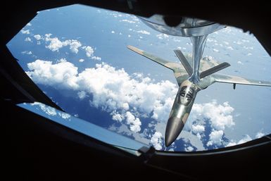 A front view, from the boom operator's section of a Royal Australian Air Force F-111 aircraft maneuvering into position for refueling by a KC-135 Stratotanker aircraft. The KC-135 is en route from Guam to Darwin Royal Australian Air Force Base, Australia, as part of Exercise Glad Customer '82