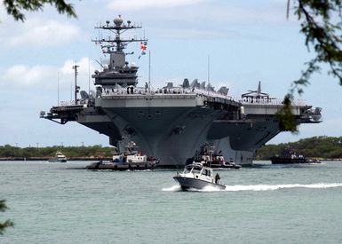 US Navy (USN) Sailors aboard the USN Nimitz Class Aircraft Carrier USS JOHN C. STENNIS (CVN 74) "man the rails" as the ship arrives in Pearl Harbor, Hawaii. The STENNIS and Carrier Air Wing 14 (CVW-14) are taking part in Rim of the Pacific (RIMPAC) 2004. RIMPAC is the largest international maritime exercise in the waters around the Hawaiian Islands. This year's exercise includes seven participating nations: Australia, Canada, Chile, Japan, South Korea, the United Kingdom and the United States. RIMPAC enhances the tactical proficiency of participating units in a wide array of combined operations at sea, while enhancing stability in the Pacific Rim region