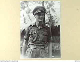 BOUGAINVILLE, SOLOMON ISLANDS. 1945-03-20. VX37706 LIEUTENANT H. ROBERTS, NEW GUINEA ADMINISTRATIVE UNIT, ATTACHED TO 7TH INFANTRY BRIGADE. HE CONTROLS NATIVE PATROLS AND RECONNOITRES TRACKS AND ..