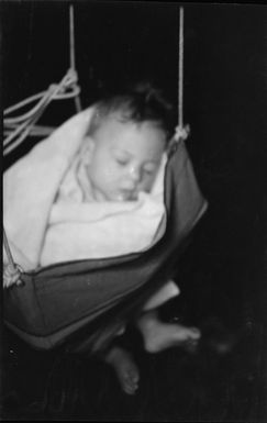 Ray Hare asleep in a door swing