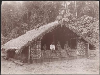 Three men and a boy sitting in a gamal at Ahia, Solomon Islands, 1906 / J.W. Beattie