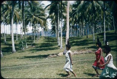 Women's foot races balancing a bottle on each head : Mapamoiwa Station, D'Entrecasteaux Islands, Papua New Guinea, 1957 / Terence and Margaret Spencer