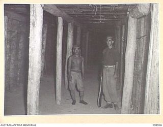 RABAUL, NEW BRITAIN. 1945-11-20. THE INTERIOR OF ONE OF THE TUNNELS IN 11 DIVISION AREA WHICH WAS USED FOR THE STORAGE OF JAPANESE AMMUNITION. THE JAPANESE MADE EXTENSIVE USE OF TUNNEL SYSTEMS AS A ..