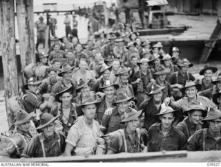 MILFORD HAVEN, LAE, NEW GUINEA. 1944-10-06. A BARGE LOADED WITH TROOPS OF B AND C COMPANIES, 36TH INFANTRY BATTALION WAITING TO BOARD THE DUTCH TROOPSHIP, "SWARTENHONDT" FOR THE UNIT'S MOVE TO NEW ..