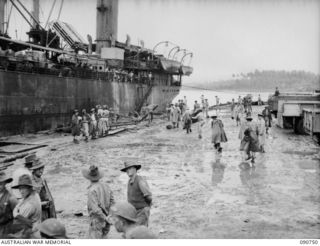 MILNE BAY, NEW GUINEA. 1942-09-14. SS KREMER IN THE PROCESS OF UNLOADING MEN AND EQUIPMENT AT PONTOON WHARF