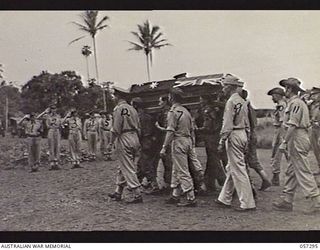 Soputa, New Guinea. 29 September 1943. High ranking officers salute as the funeral party moves into the cemetery, during the funeral of Brigadier (Brig) R. B. Sutherland. Shown: Lieutenant General ..