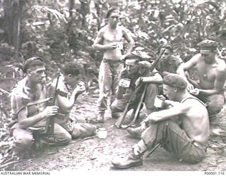 THE SOLOMON ISLANDS, 1945-04-24/27. AN AUSTRALIAN ARMY PATROL PAUSES FOR A MUG OF TEA ON BOUGAINVILLE ISLAND. (RNZAF OFFICIAL PHOTOGRAPH.)