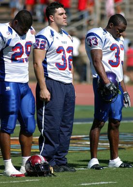US Naval Academy (USNA) Midshipman First Class (MIDN 1/C) Kyle Eckel (32) stands at attention during the playing of the National Anthem at the 2005 Hula Bowl All-Star game in Kahului, Maui. MIDN 1/C Eckel is the 24th player in school history to be selected for the Hula Bowl All-Star game, but did not play because of an ankle injury sustained during practice. MIDN 1/C Eckel, also selected to play in the East-West Shrine game and the Gridiron Classic, is one of just six players in school history to be selected to three or more all-star games