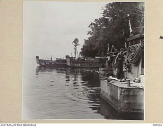 JACQUINOT BAY, NEW BRITAIN. 1945-04-12. BARGES AWAITING REPAIR LINE THE BANKS OF THE CAMP AREA, 3016 ENGINEER BOAT MAINTENANCE COMPANY (US ARMY), ATTACHED 5 DIVISION. THEY WILL RETURN TO THE ..