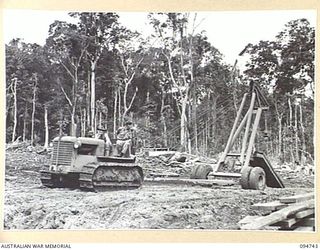 YALU AREA, NEW GUINEA, 1945-07-30. AN M 20 CRANE BEING OPERATED BY MEMBERS OF NO. 3 PLATOON, 2/1 FORESTRY COMPANY, ROYAL AUSTRALIAN ENGINEERS