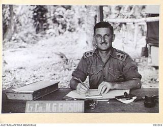 BOUGAINVILLE, 1945-06-18. LT-COL M.G. EDISON, WORKING IN HIS OFFICE AT 109 CASUALTY CLEARING STATION, MOTUPENA POINT