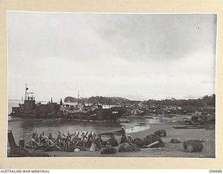 AITAPE, NEW GUINEA. 1945-04-19. SUPPLIES BEING UNLOADED FROM BARGES AT THE BEACH HEAD