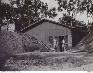 PORT MORESBY, NEW GUINEA. 1943-07-14. THIS CARRIER TERMINAL BUILDING WAS CONSTRUCTED BY THE ROYAL AUSTRALIAN ENGINEERS AT THE 5TH UNITED STATES ARMY AIR FORCE BASE, THE OPEN POLE AND WIRE ROUTE WAS ..