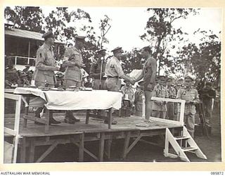 HERBERTON, QLD. 1945-01-19. LIEUTENANT GENERAL SIR LESLIE J MORSHEAD, GENERAL OFFICER COMMANDING 1 CORPS, (4), PRESENTS A LEATHER WRITING CASE TO LANCE BOMBARDIER H T WARHURST, 2/7 FIELD REGIMENT, ..